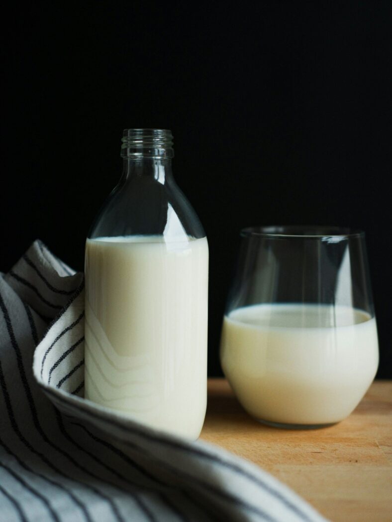 glass and container of milk