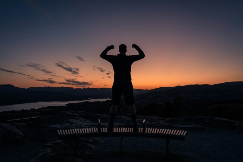 man flexing at sunset