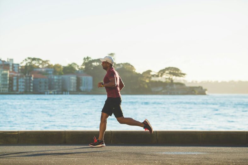 man running next to water