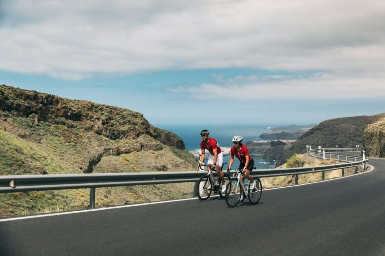 two cyclists along the coast