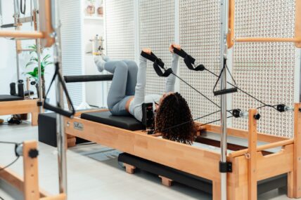 woman doing pilates / pilates power tower class