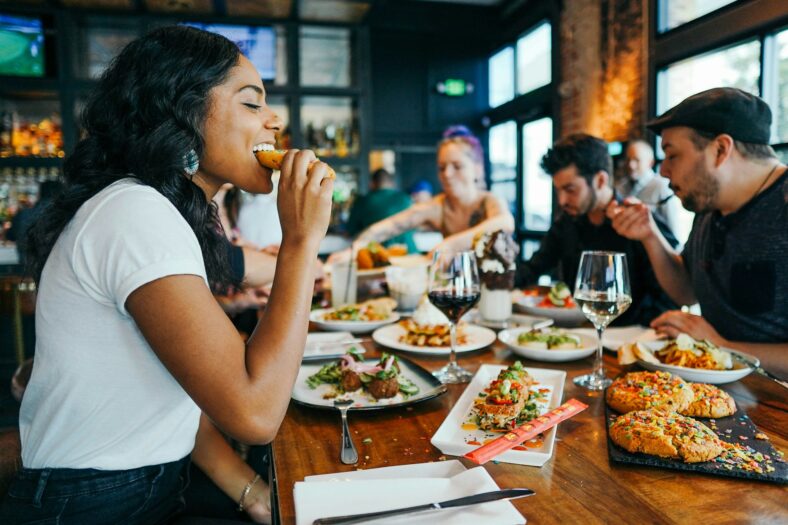 woman smiling while eating