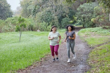 two women running together / working out with friends