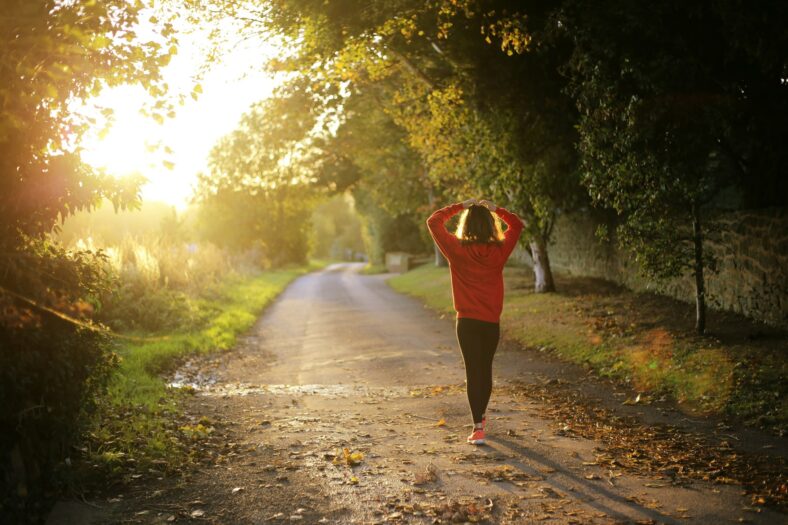 woman walking with hands on her head