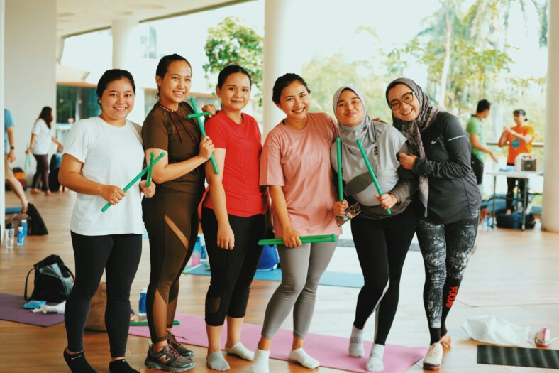 women smiling while working out