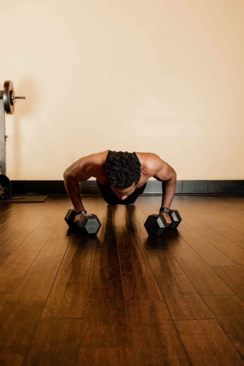 man doing push up with dumbbells