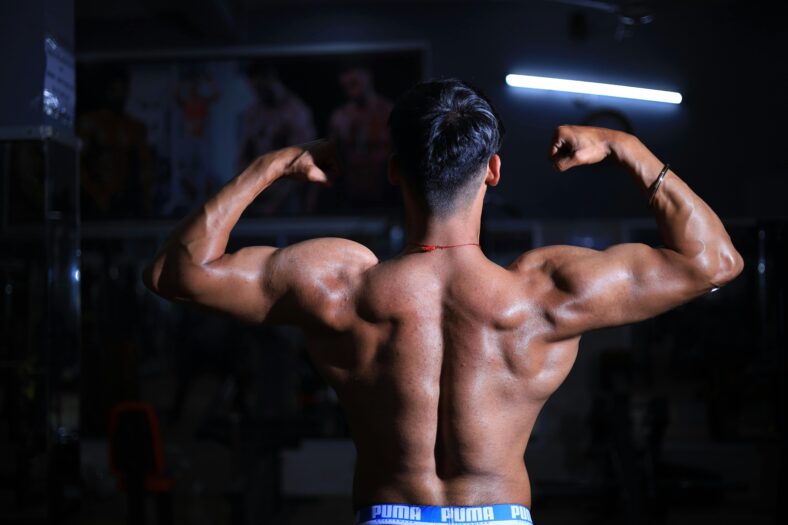 man flexing upper body muscles