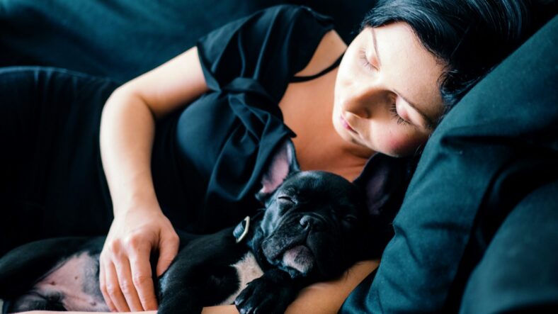 woman sleeping with dog