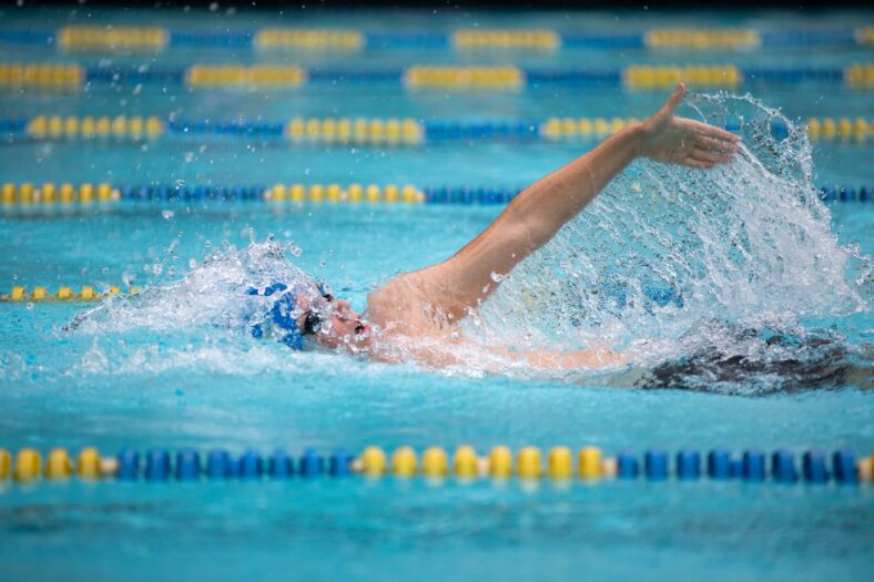 man swimming in pool
