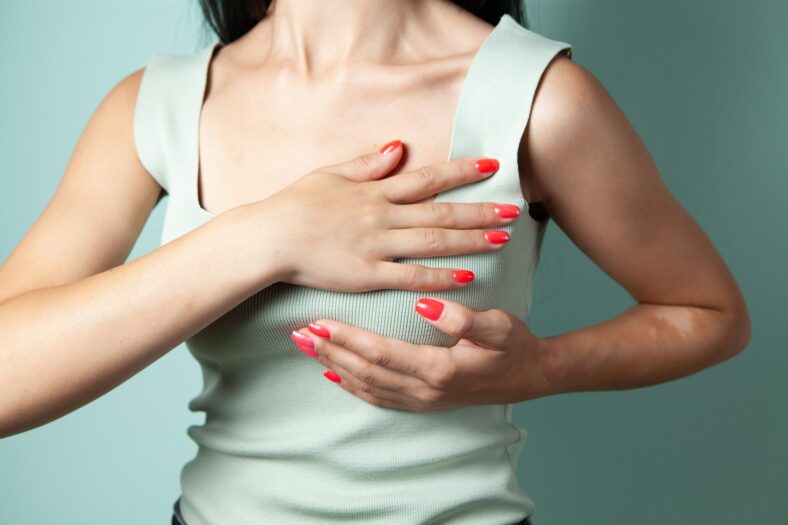 woman pushing down on breast