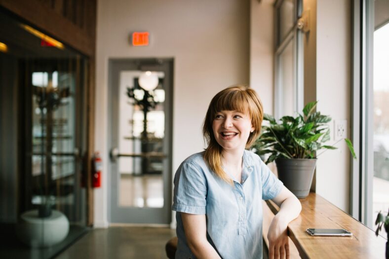 woman sitting at counter smiling